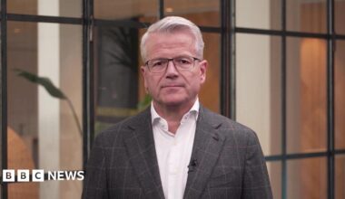 Maersk chief executive Vincent Clerc wears a white shirt, brown suit jacket and glasses as he speaks to the BBC.