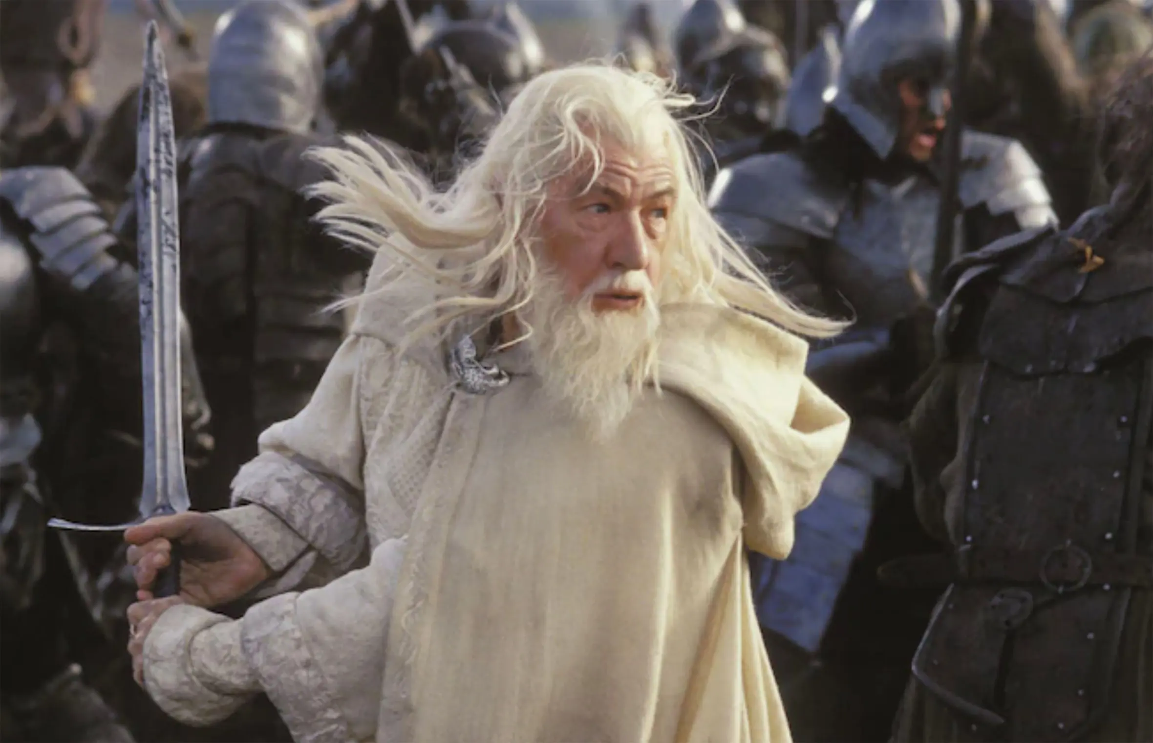 Ian McKellen as Gandalf holding a sword in a battle scene from The Lord of the Rings: The Return of the King.