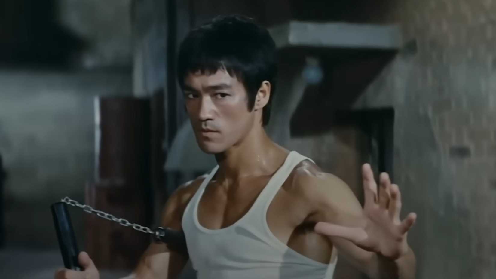 Bruce Lee holding nunchuks ready for combat in The Way of the Dragon