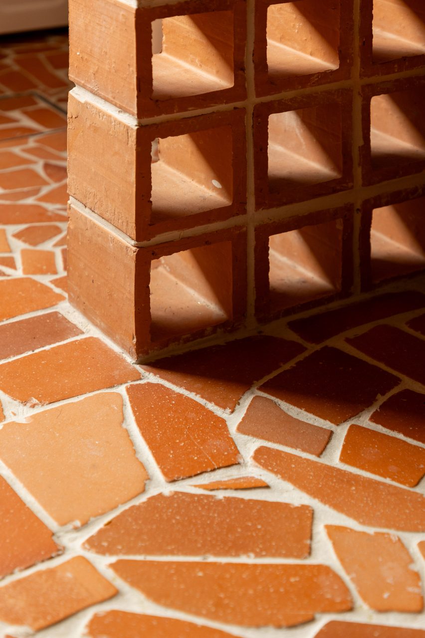 Detail of stacked terracotta blocks atop a tile-fragment floor