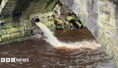 A combined sewer overflow pipe discharging fast flowing water into the River Calder at Hebden Bridge. The water looks comparatively clean and is likely to be a mixture of rainwater and wastewater.