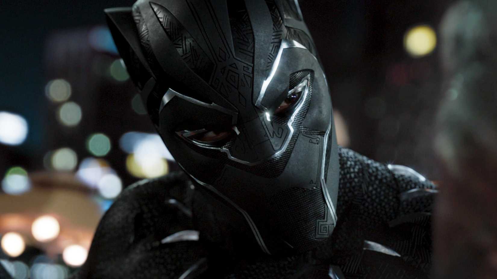 Chadwick Boseman's Black Panther about to attack a man in Black Panther (2018)