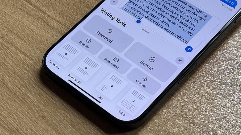 A close up shot of an iPhone and its Writing Tools feature