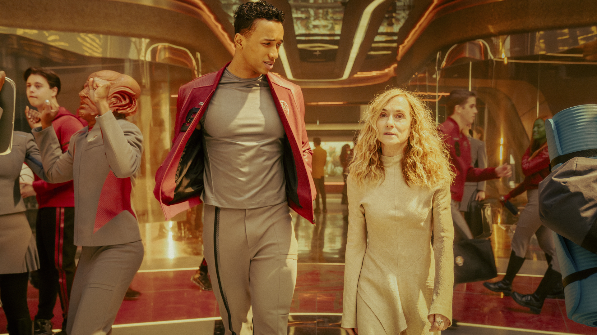 people in futuristic clothing in a brightly lit room