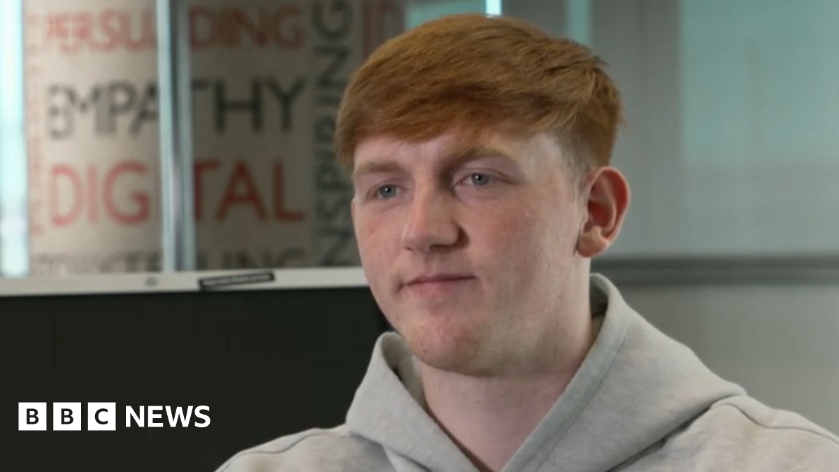 A teenage girl in school uniform stares at a phone