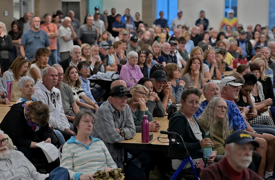 A school cafeteria full of Wingfield Springs residents listen during a meeting that was held to discuss the proposed project to build 764 residential units on the Red Hawk Golf Course on March 12, 2016.