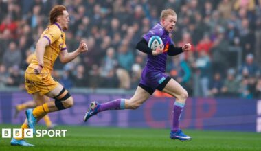 Josh Hodge of Exeter Chiefs goes over for a try beating George Hendy of Northampton Saints during the Prem Rugby Cup Semi Final at Sandy Park.