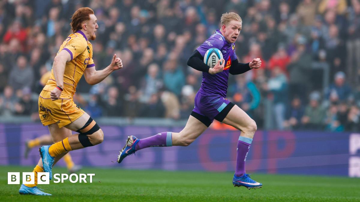 Josh Hodge of Exeter Chiefs goes over for a try beating George Hendy of Northampton Saints during the Prem Rugby Cup Semi Final at Sandy Park.