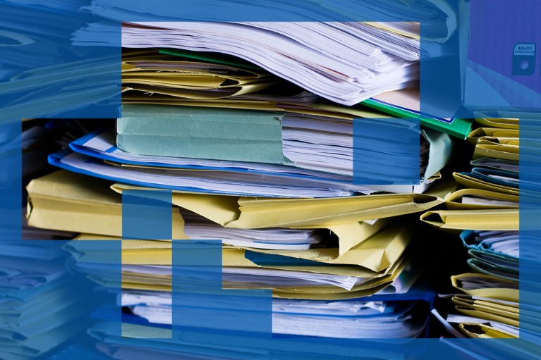 Large, messy piles of folders containing paper documents.