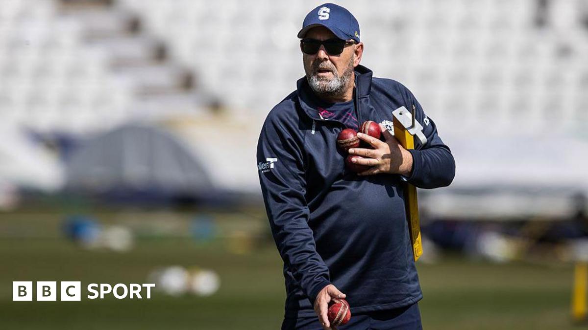 Darren Lehmann prepares to catch a cricket ball while wearing a baseball mitt