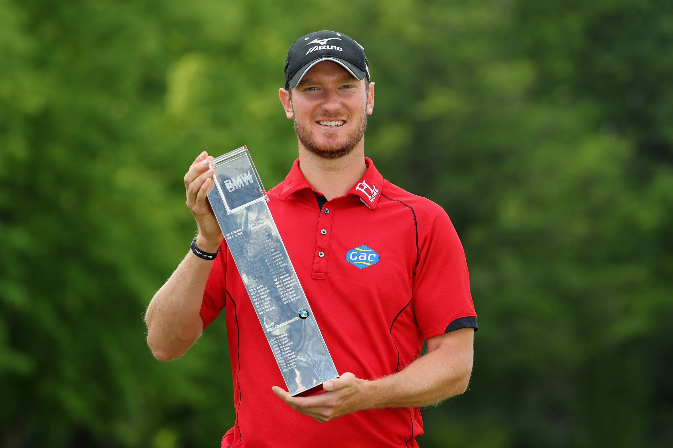 Chris Wood poses with the BMW PGA Championship trophy.
