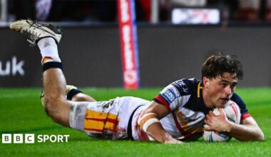Catalans Dragons' Lewis Dodd diving over to score a try