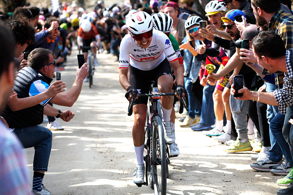 Niewiadoma riding through the crowds on the gravel of Strade Bianche