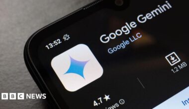 A close up of a smartphone with the Google Gemini AI app ready to download from an app store