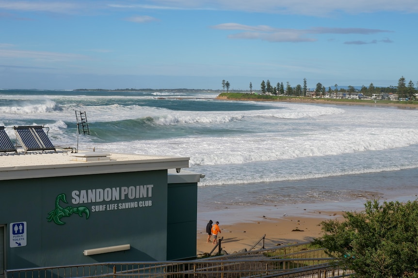 The Sandon Point Surf Life Saving Club building with large waves seen in the distance.