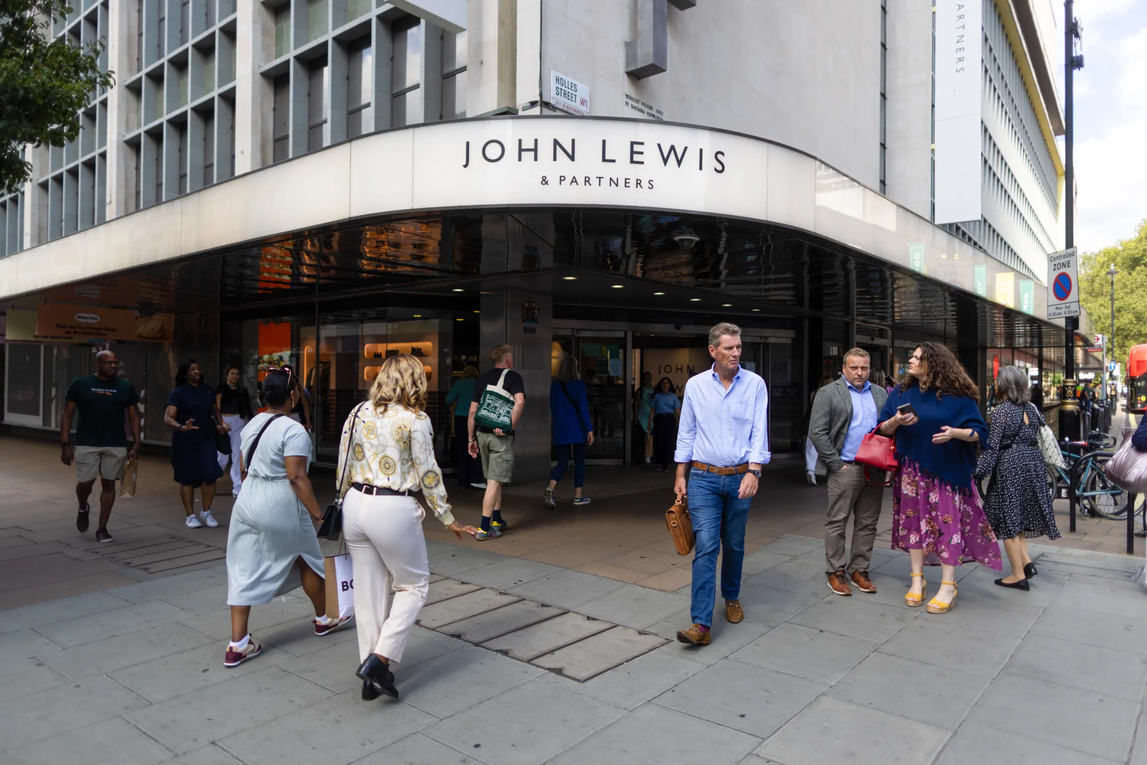 Pedestrians walk outside the John Lewis department store in London.