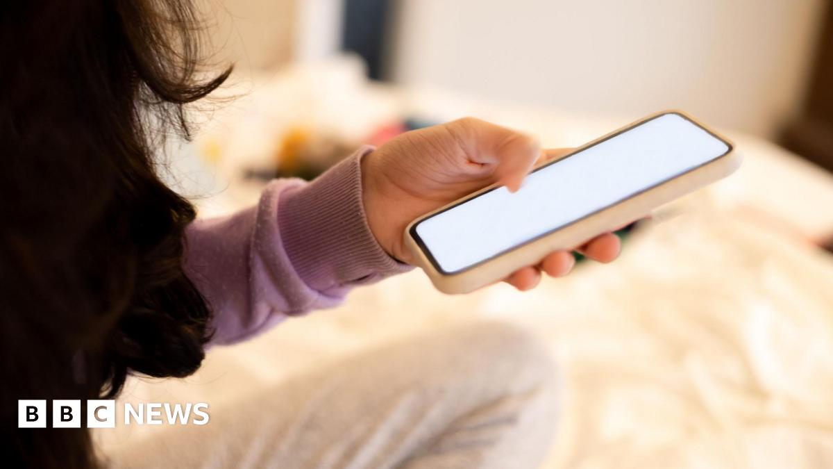 Teenage girl looking at mobile phone