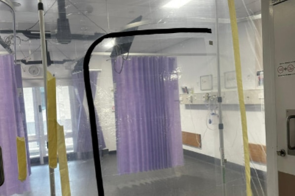 Plastic sheeting strung up around a hospital curtain.