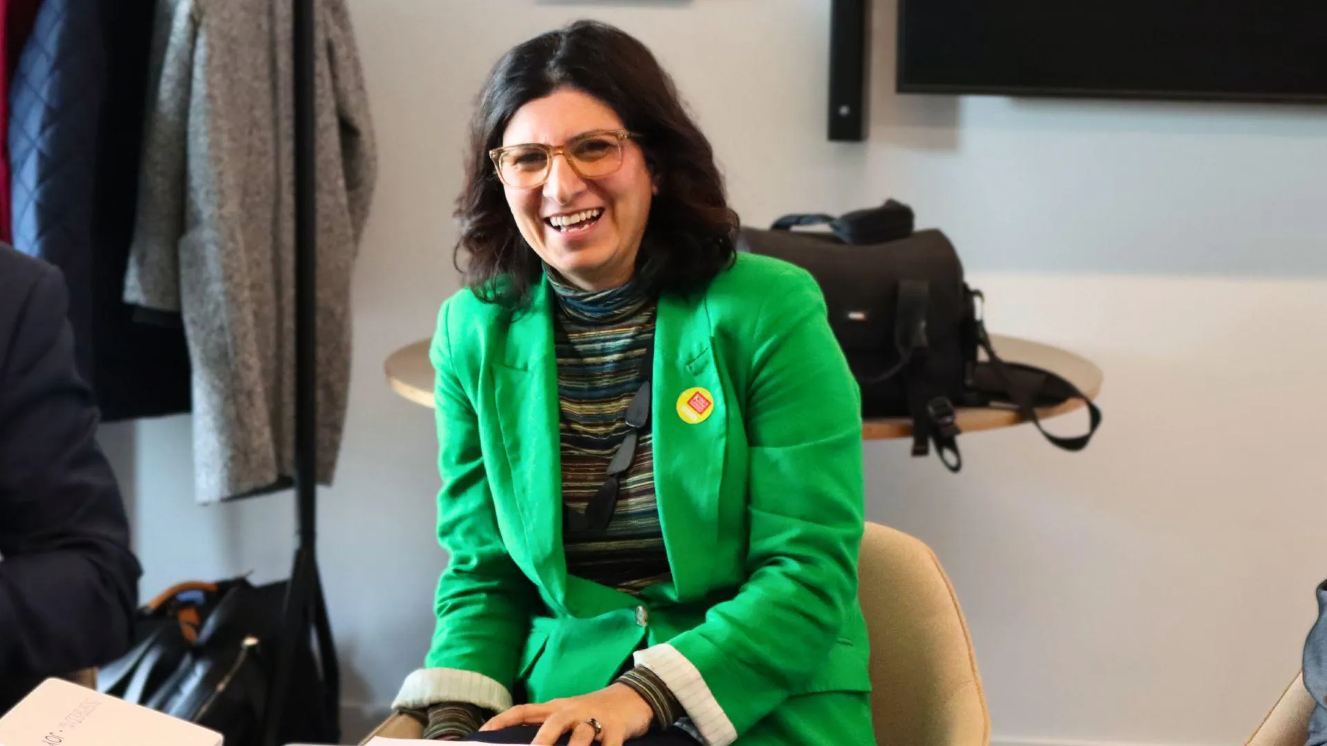 Woman smiling in green blazer