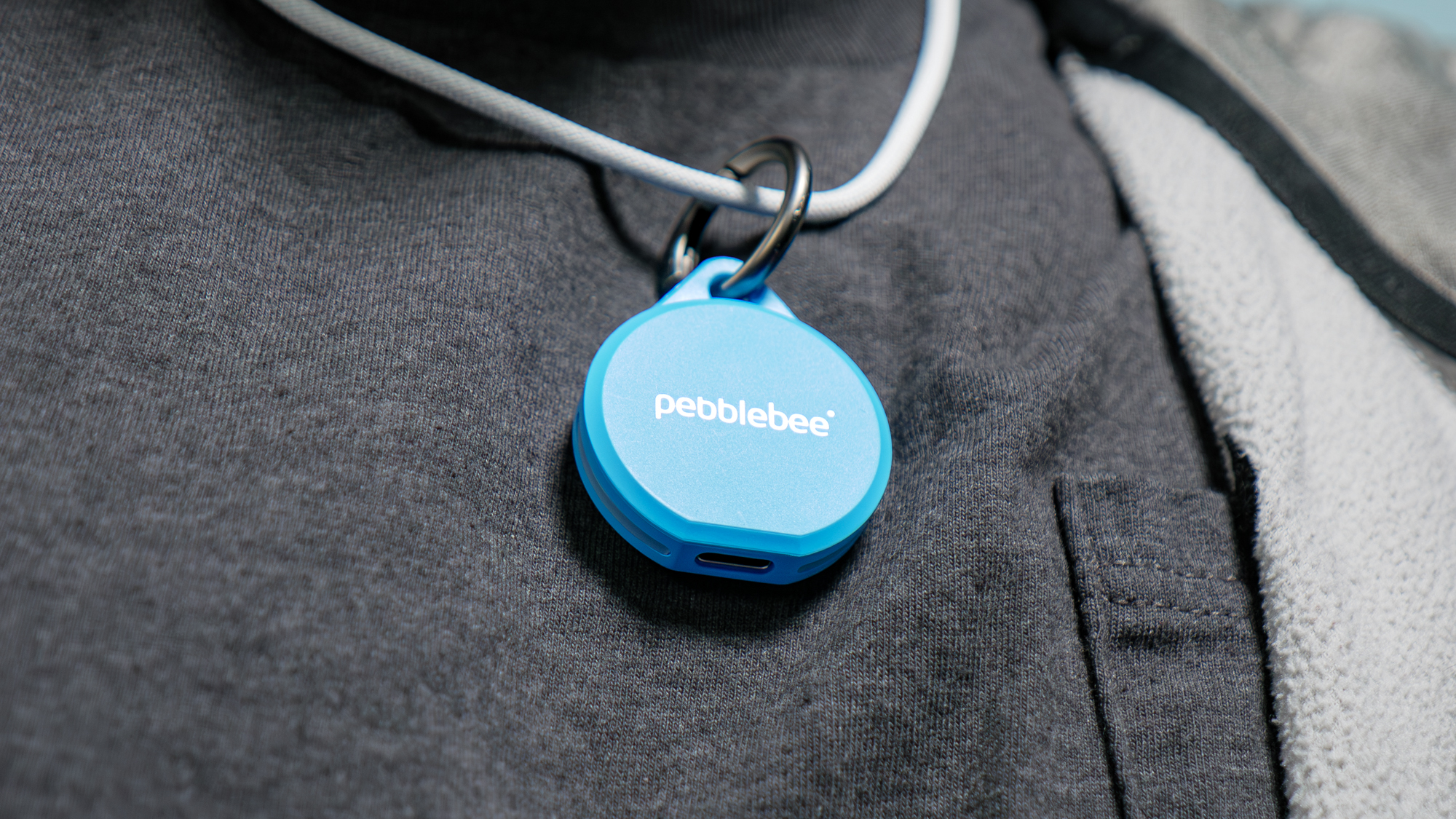 Pebblebee Clip 5 held in the hand.