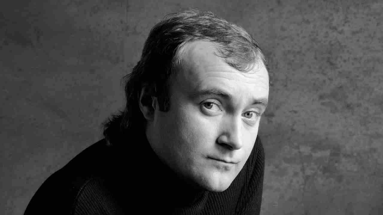 Phil Collins posing for a photograph in 1985