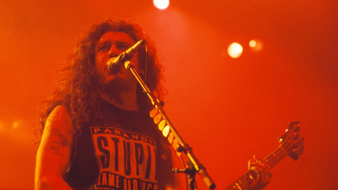 Tom Araya on stage in 1991, bathed in red light