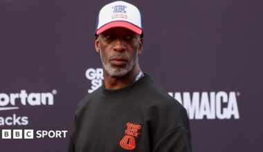 Former athlete Michael Johnson wearing a Grand Slam Track jumper and cap at the league's event in Philadelphia in 2025