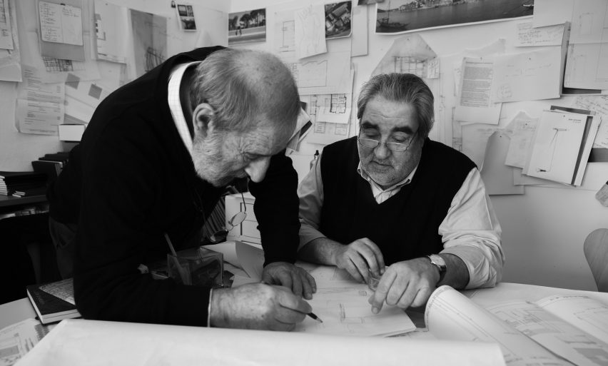 Eduardo Souto de Moura and Siza Vieira reviewing architectural drawings together in a studio
