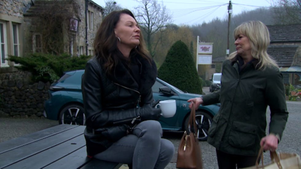 emmerdale chas dingle kim tate two women engaged in conversation outside a building
