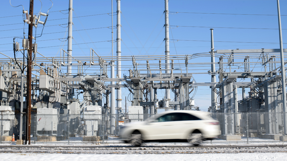 A car drives by an electrical grid station in Houston, Texas, US, on Tuesday, Jan. 21, 2025.