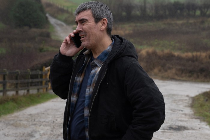 Cain looking determined while on the phone in Emmerdale
