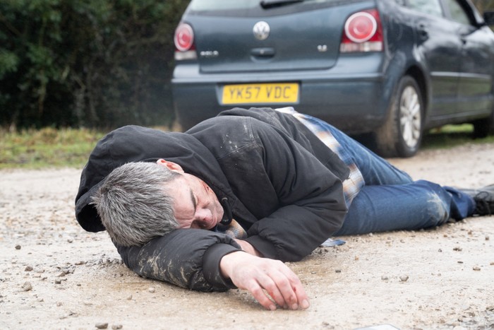 Cain laying on the ground unconscious in Emmerdale