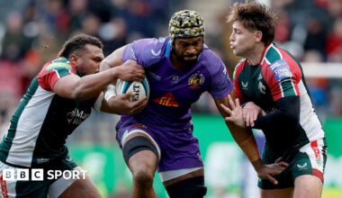 Exeter Chiefs' Christ Tshiunza bursts through the challenges of two Leicester Tigers players