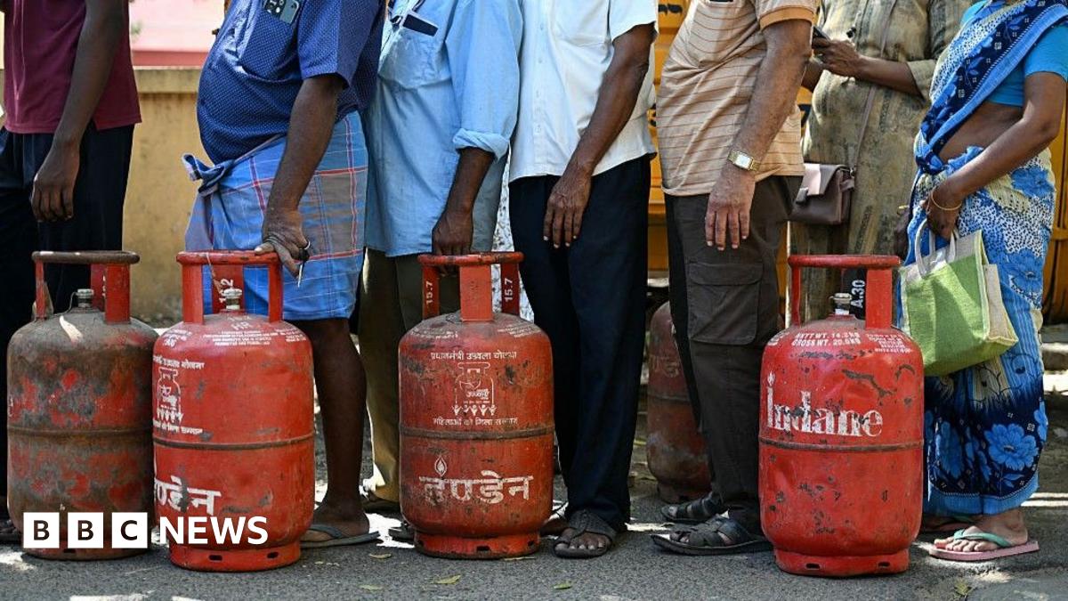 People queue to buy liquefied petroleum gas (LPG) cylinders for domestic use, at a gas agency office in Chennai.