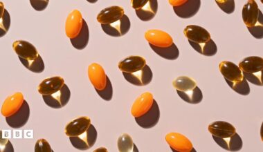 Various soft gel capsules on beige background