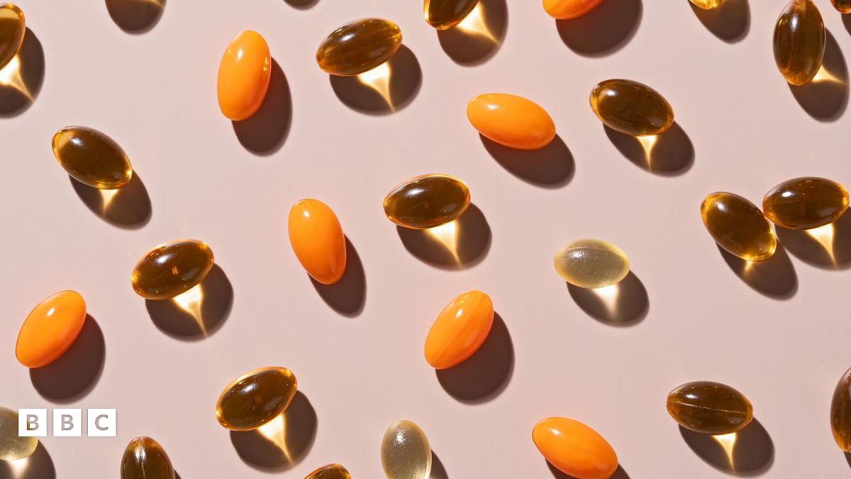 Various soft gel capsules on beige background