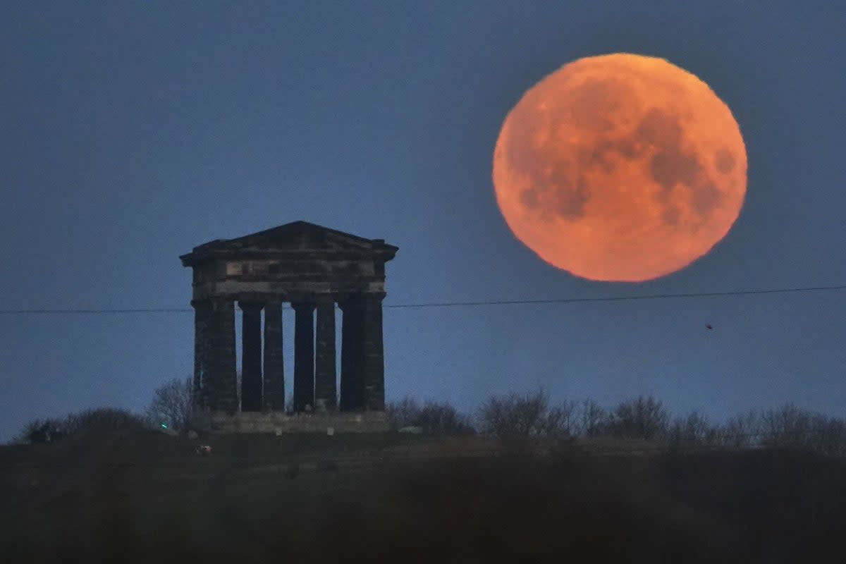 A full moon, known as the worm moon, sets behind the Penshaw Monument, near Sunderland (Owen Humphreys/PA) (PA)