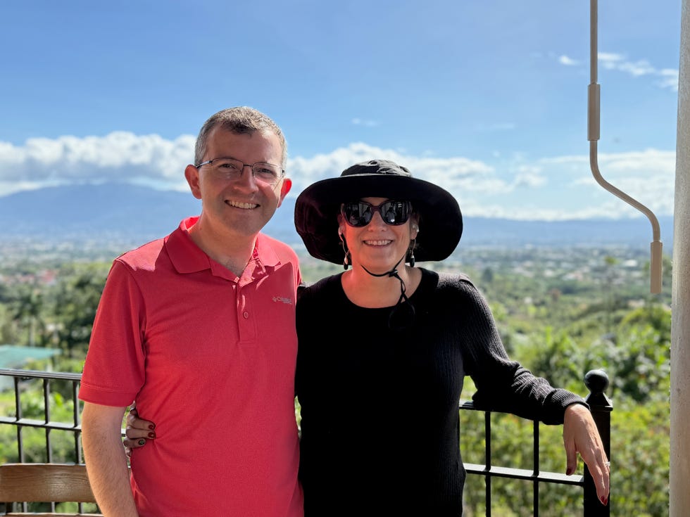 tony and carey posing together with a scenic landscape in the background