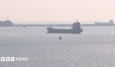 Three ships anchored in Plymouth Sound on a hazy day