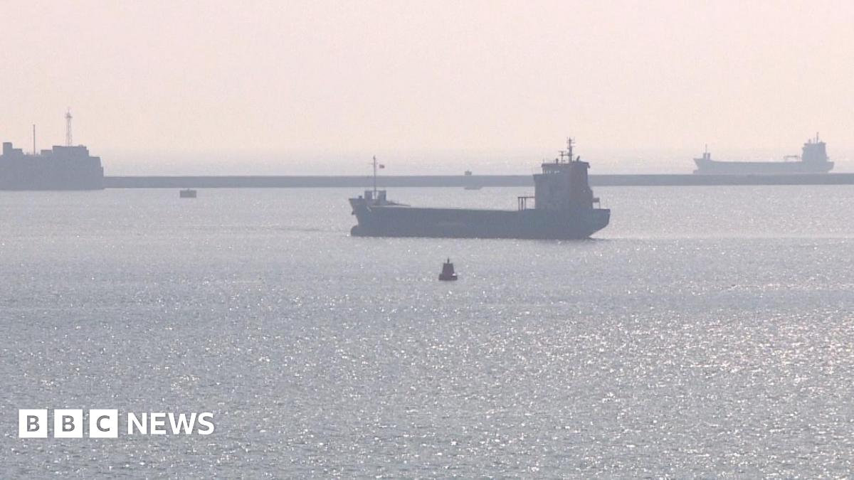 Three ships anchored in Plymouth Sound on a hazy day