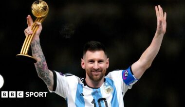 Argentina captain Lionel Messi raises his arms while holding a trophy