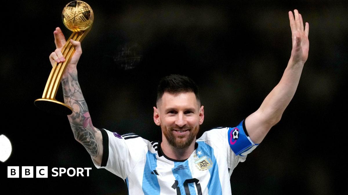 Argentina captain Lionel Messi raises his arms while holding a trophy