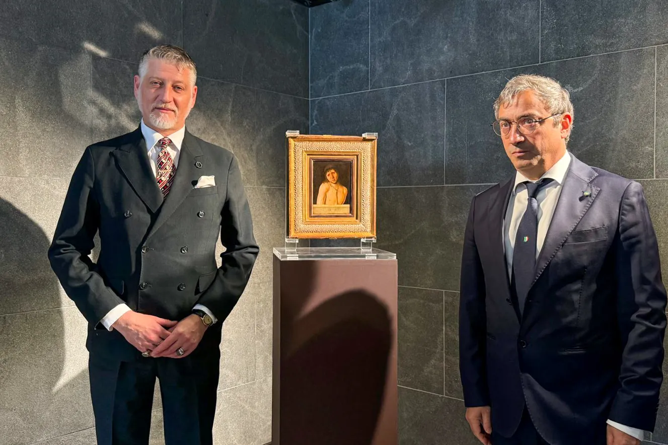 Minister of Culture Alessandro Giuli (left) and another minister standing next to Antonello da Messina's "Ecce Homo" painting.