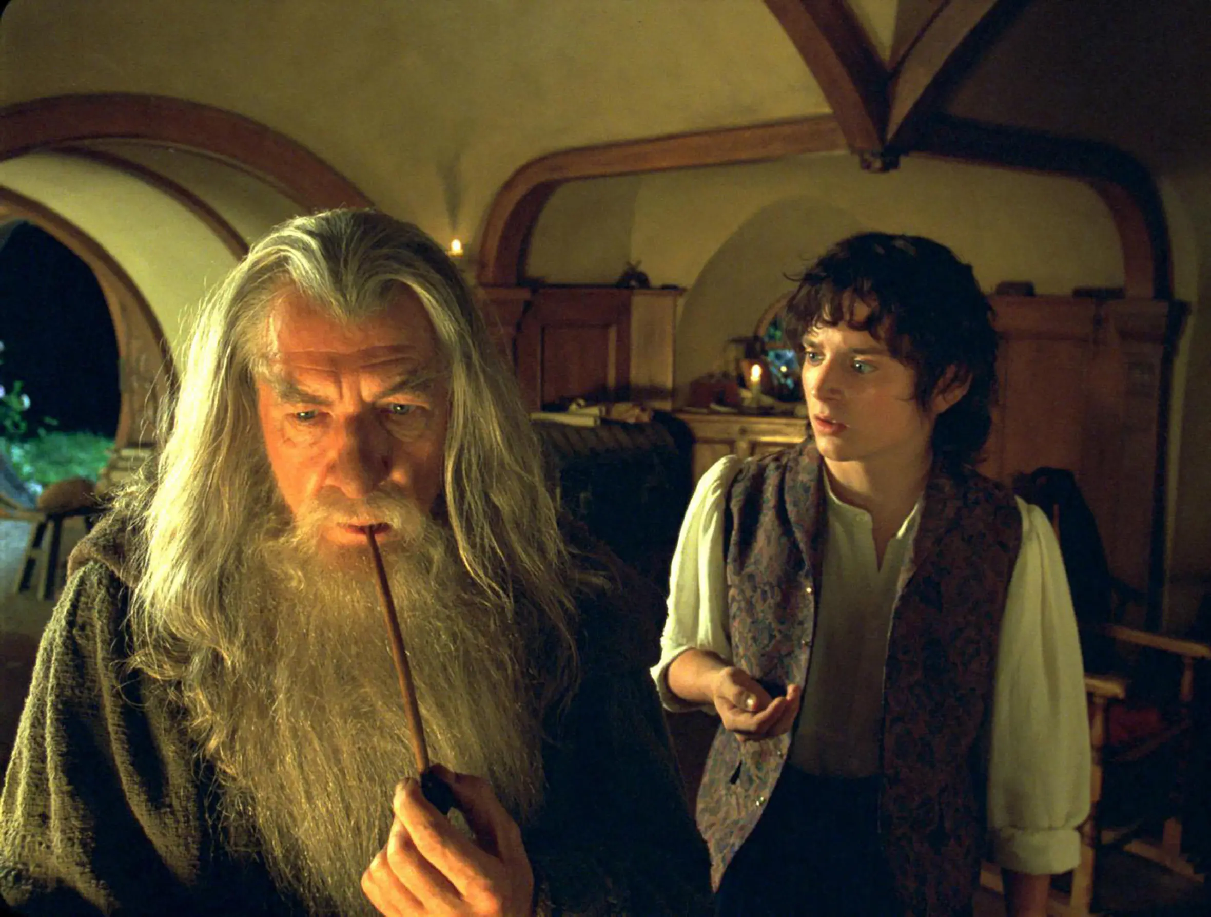 Ian McKellen as Gandalf smoking a pipe, and Elijah Wood as Frodo in "The Lord of the Rings: The Fellowship of the Ring."