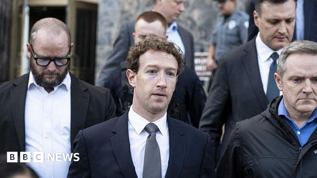 Mark Zuckerberg, wearing a navy suit and grey tie, leaving court in Los Angeles in February, flanked other personnel.
