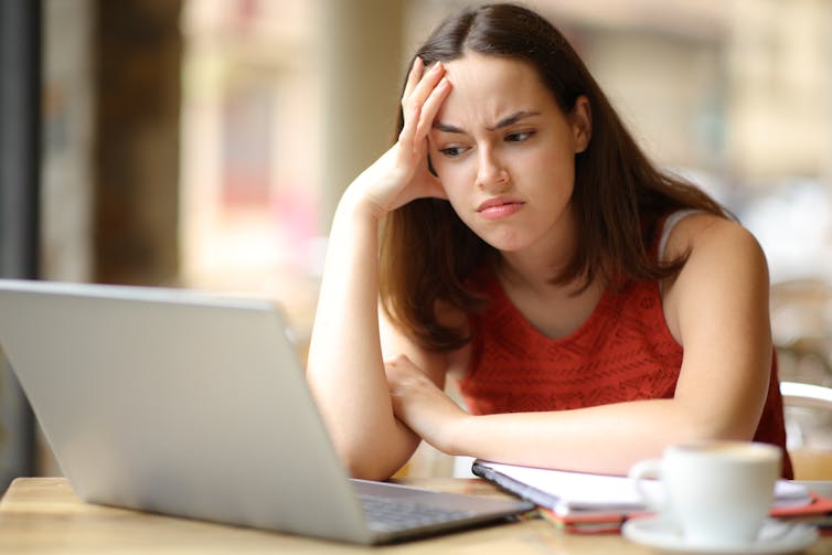 Girl frowning at laptop