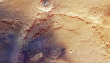 image of the mars surface taken by a mars orbiter, showing several large, heavily eroded craters