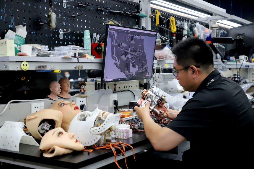 A technician works on the bionic humanoid robots at a workshop of Ex-Robots factory on June 23, 2025 in Dalian, Liaoning province.