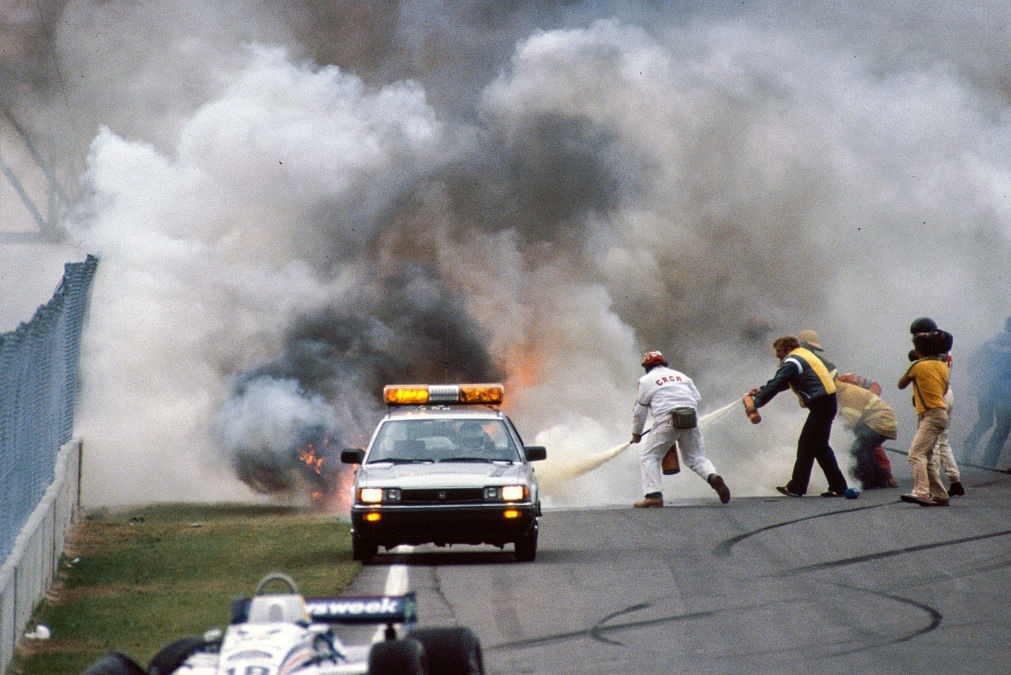 Marshals try to extinguish the blaze after Ricciardo Paletti's Osella struck the rear of Didier Pironi's stalled Ferrari at the start of the 1982 Canadian Grand Prix