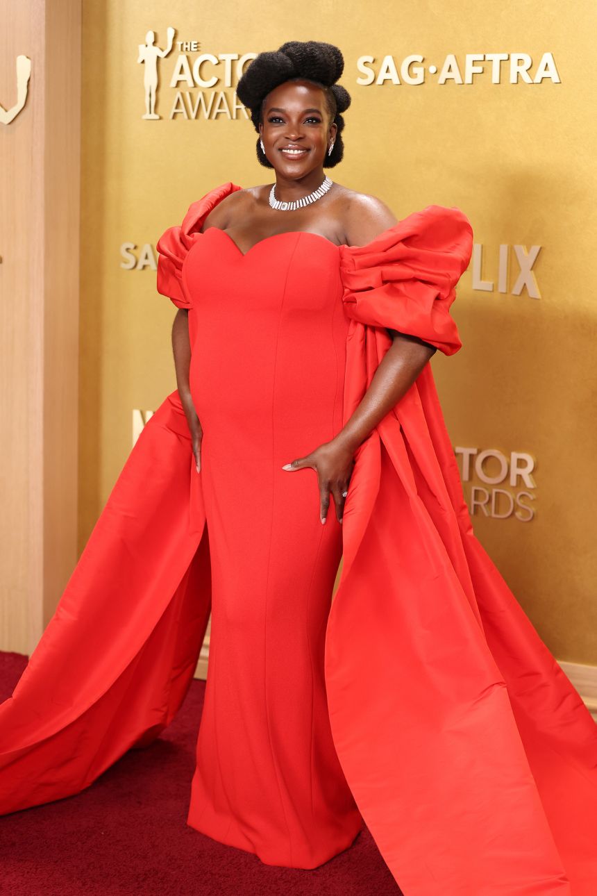 “Sinners” actor Wunmi Mosaku wore a red Louis Vuitton gown with heart-shaped bustier and voluminous silk taffeta sleeves.